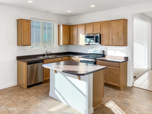 kitchen with appliances with stainless steel finishes, a center island, and sink