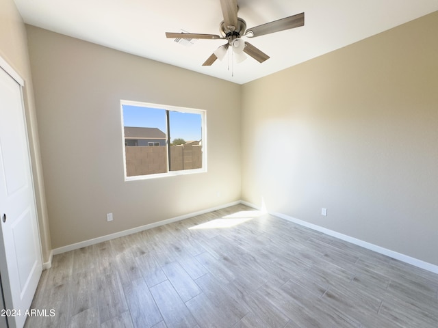 spare room featuring ceiling fan and light hardwood / wood-style floors