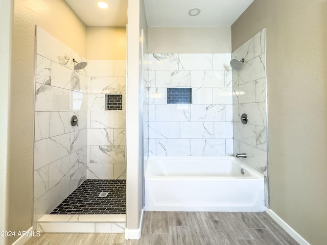 bathroom featuring shower with separate bathtub