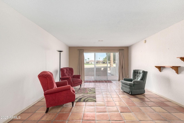 living area featuring a textured ceiling and light tile patterned flooring