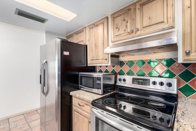 kitchen with stainless steel appliances, light stone countertops, light brown cabinets, and decorative backsplash