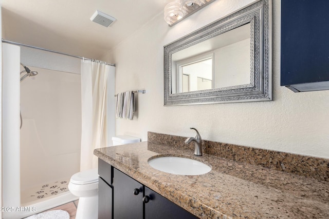 bathroom featuring vanity, toilet, and curtained shower