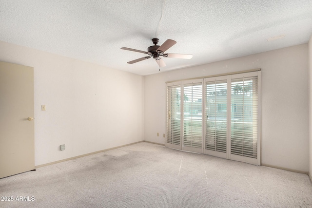 unfurnished room with ceiling fan, light colored carpet, and a textured ceiling