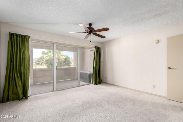 unfurnished room featuring ceiling fan, a textured ceiling, and carpet flooring