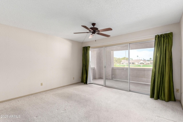 carpeted spare room featuring ceiling fan and a textured ceiling