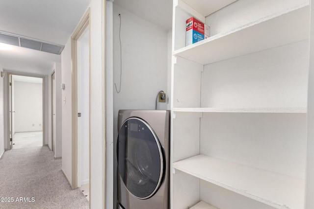 laundry room featuring washer / dryer and light colored carpet