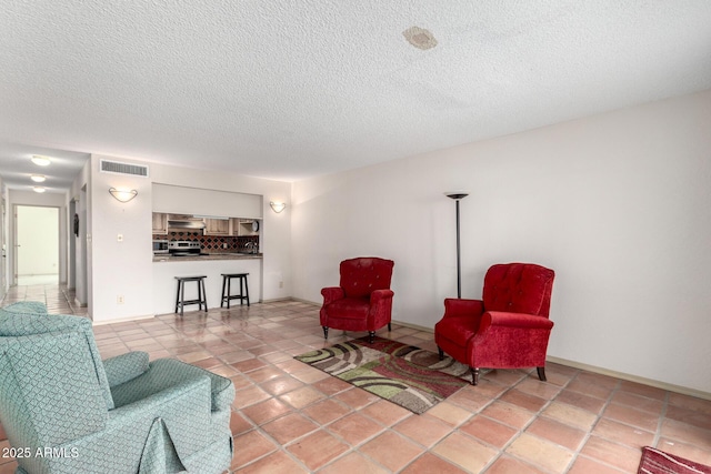 sitting room featuring light tile patterned floors and a textured ceiling