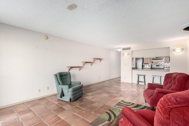 tiled living room with a textured ceiling