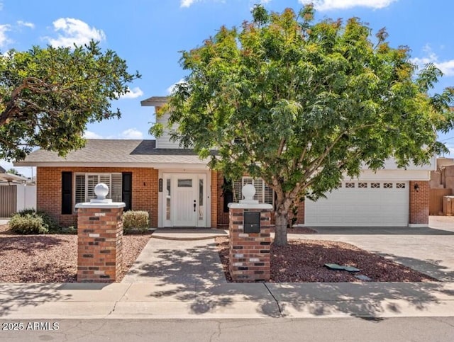 8545 E Heatherbrae Dr, Scottsdale, AZ 85251 - view of front of property with driveway, brick siding, and an attached garage