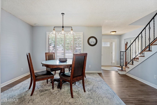 8545 E Heatherbrae Dr, Scottsdale, AZ 85251 - dining room featuring a textured ceiling, dark wood-style floors, stairs, and baseboards
