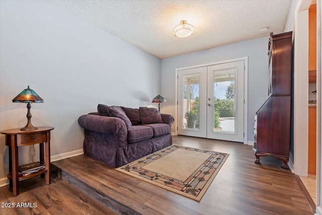 8545 E Heatherbrae Dr, Scottsdale, AZ 85251 - living area featuring french doors, a textured ceiling, wood finished floors, and baseboards