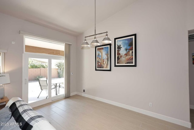 interior space with lofted ceiling and baseboards