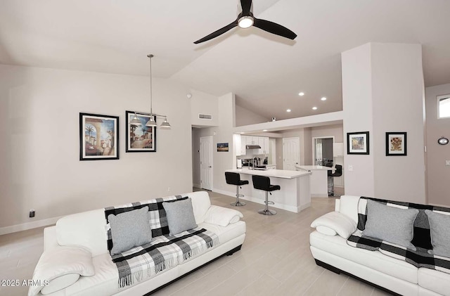 living area featuring visible vents, baseboards, lofted ceiling, recessed lighting, and a ceiling fan