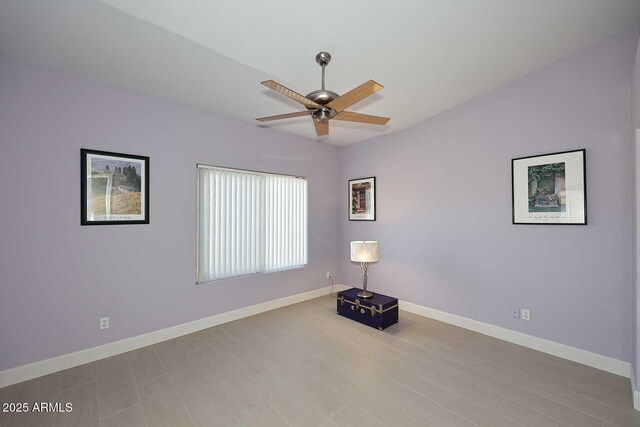 unfurnished room with wood finished floors, baseboards, and ceiling fan