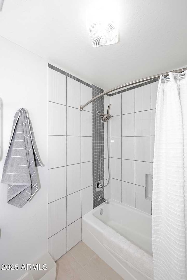 bathroom with tile patterned floors, visible vents, and shower / tub combo with curtain