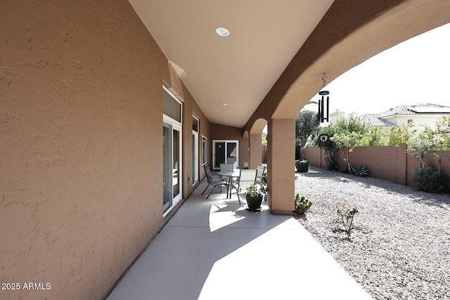 view of patio featuring outdoor dining area and fence