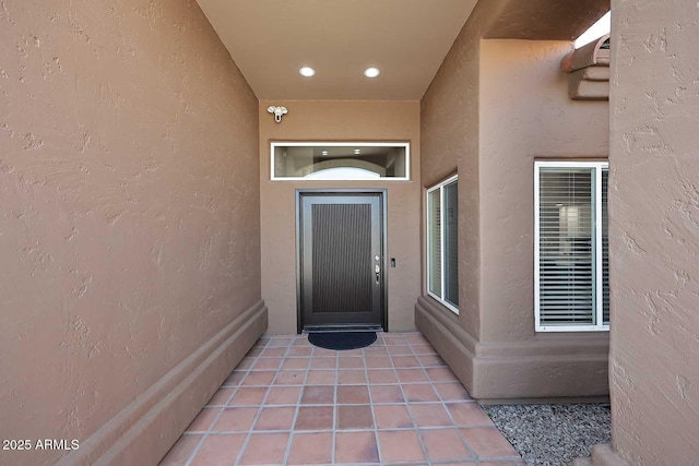 view of exterior entry featuring stucco siding