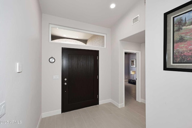 foyer with recessed lighting, baseboards, and visible vents