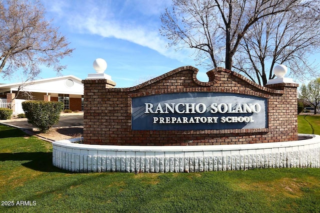 community sign featuring a lawn