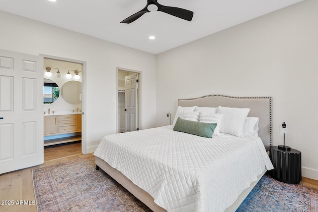 9708 E Via Linda Rd Unit 1350, Scottsdale, AZ 85258 - bedroom featuring recessed lighting, wood finished floors, connected bathroom, baseboards, and ceiling fan