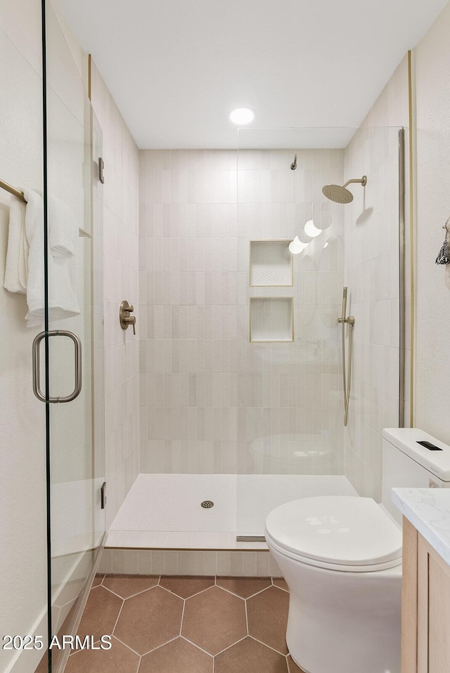 9708 E Via Linda Rd Unit 1350, Scottsdale, AZ 85258 - bathroom with toilet, a shower stall, tile patterned floors, and vanity