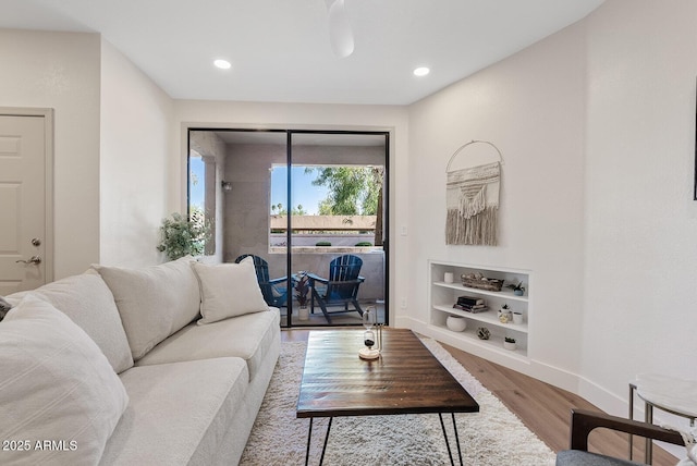 9708 E Via Linda Rd Unit 1350, Scottsdale, AZ 85258 - living room featuring built in shelves, baseboards, wood finished floors, and recessed lighting