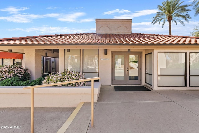 9708 E Via Linda Rd Unit 1350, Scottsdale, AZ 85258 - property entrance with french doors, a tile roof, uncovered parking, and stucco siding