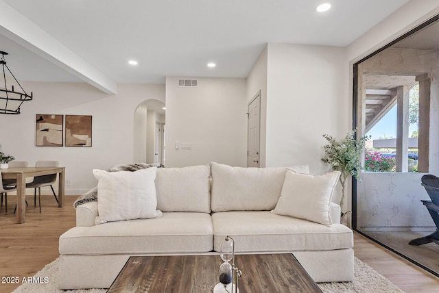 9708 E Via Linda Rd Unit 1350, Scottsdale, AZ 85258 - living room featuring arched walkways, light wood-type flooring, recessed lighting, and baseboards