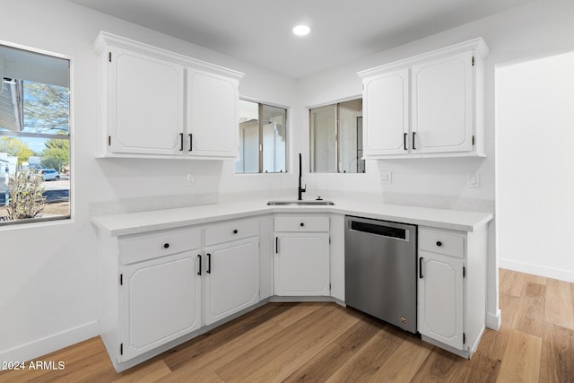 kitchen featuring sink, dishwasher, white cabinetry, and light hardwood / wood-style floors