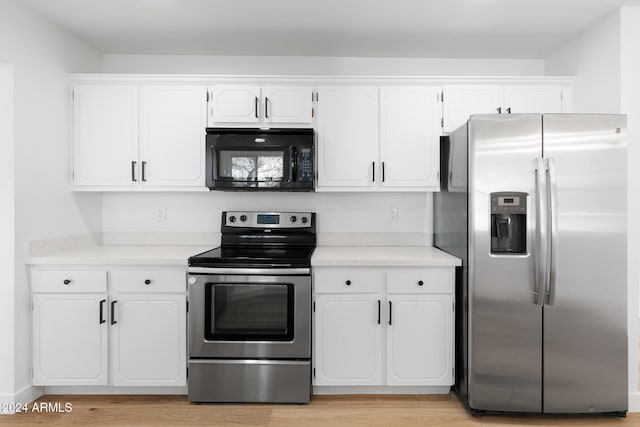 kitchen featuring white cabinets, light hardwood / wood-style flooring, and stainless steel appliances