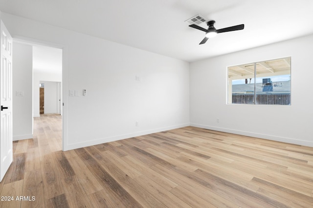 empty room with light wood-type flooring and ceiling fan