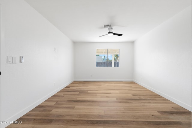 empty room with hardwood / wood-style floors and ceiling fan