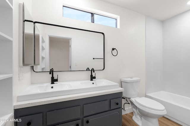 full bathroom with wood-type flooring, toilet, vanity, and bathing tub / shower combination