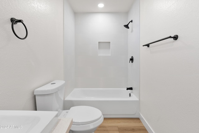 bathroom featuring shower / bath combination, hardwood / wood-style flooring, and toilet