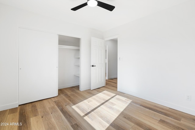 unfurnished bedroom with ceiling fan and light hardwood / wood-style flooring