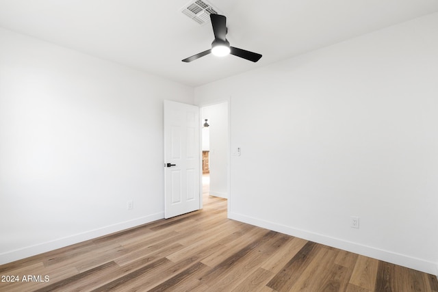 spare room featuring hardwood / wood-style floors and ceiling fan