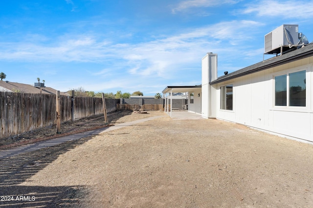 view of yard featuring a patio and central AC unit