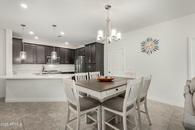 tiled dining space with an inviting chandelier and sink