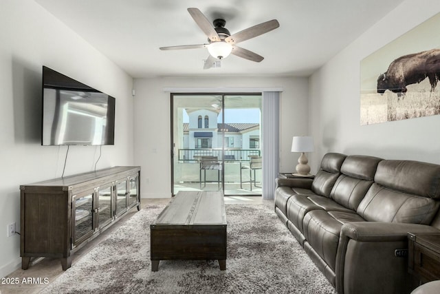 living room featuring ceiling fan and light colored carpet