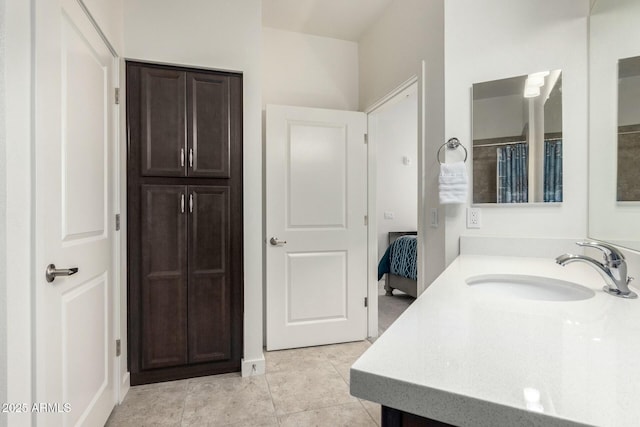 bathroom with tile patterned flooring and vanity