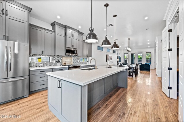 306 W Culver St, Phoenix, AZ 85003 - kitchen featuring appliances with stainless steel finishes, gray cabinets, a sink, light wood finished floors, and recessed lighting