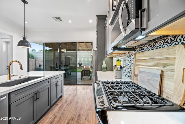 306 W Culver St, Phoenix, AZ 85003 - kitchen featuring a sink, ornamental molding, gray cabinetry, gas stove, and light countertops