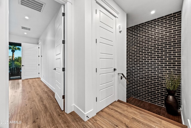 306 W Culver St, Phoenix, AZ 85003 - hall with brick wall, wood finished floors, an accent wall, and recessed lighting