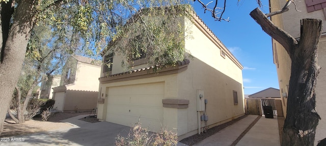 view of home's exterior with a gate and stucco siding