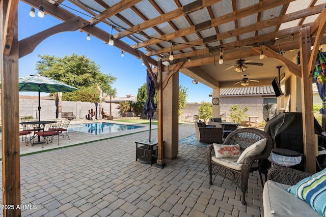 view of patio / terrace with a fenced in pool, an outdoor living space, ceiling fan, and a pergola