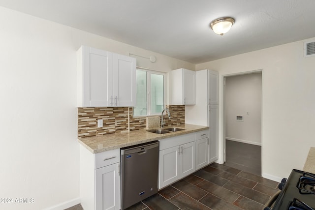 kitchen featuring tasteful backsplash, white cabinets, dark tile floors, and dishwasher