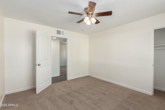 unfurnished bedroom with ceiling fan, a closet, and light carpet