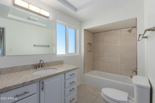 full bathroom with tiled shower / bath, toilet, tile flooring, and vanity