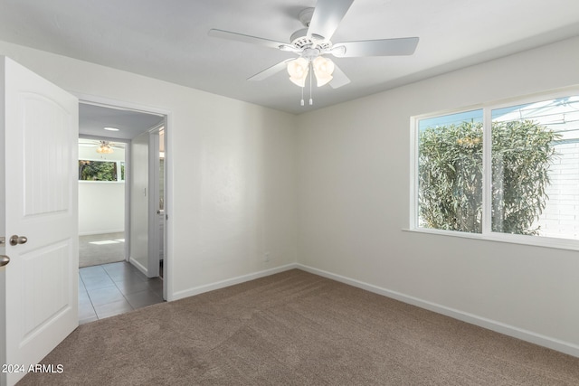 tiled empty room with ceiling fan