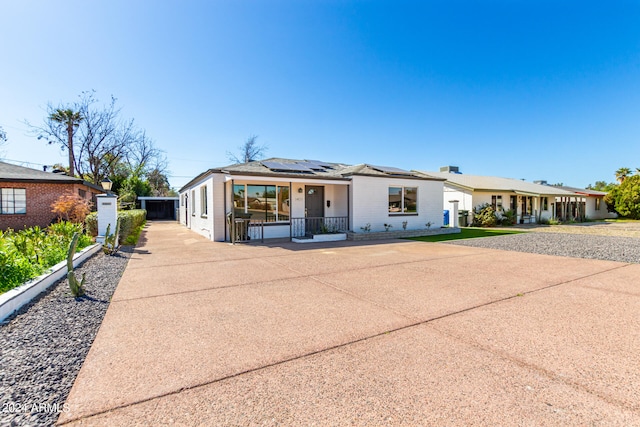 single story home featuring solar panels